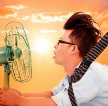 Air_Conditioning_heat_wave_coming_business_man_holding_a_electric_fan_Heat_Wave_Heat_Temperature_Sweat_Summer_Electric_Fan